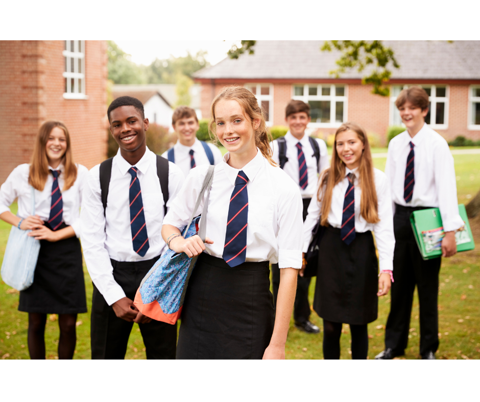 group of teens facing the camera, smiling, wearing school uniform