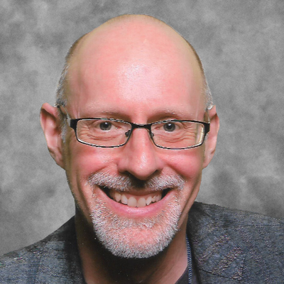 RICHARD WISEMAN IMAGE OF RICHARD WISEMAN, A WHITE MAN WITH GLASSES, A GREY BEARD AND A BIG SMILE