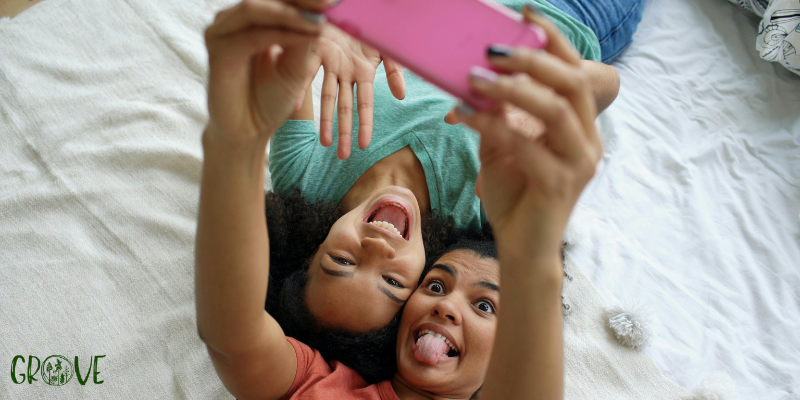 two black teens lying down making faces for a photo