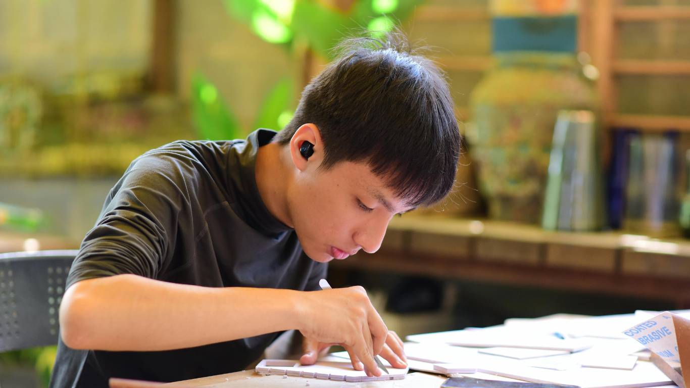 image of a young person working at a table