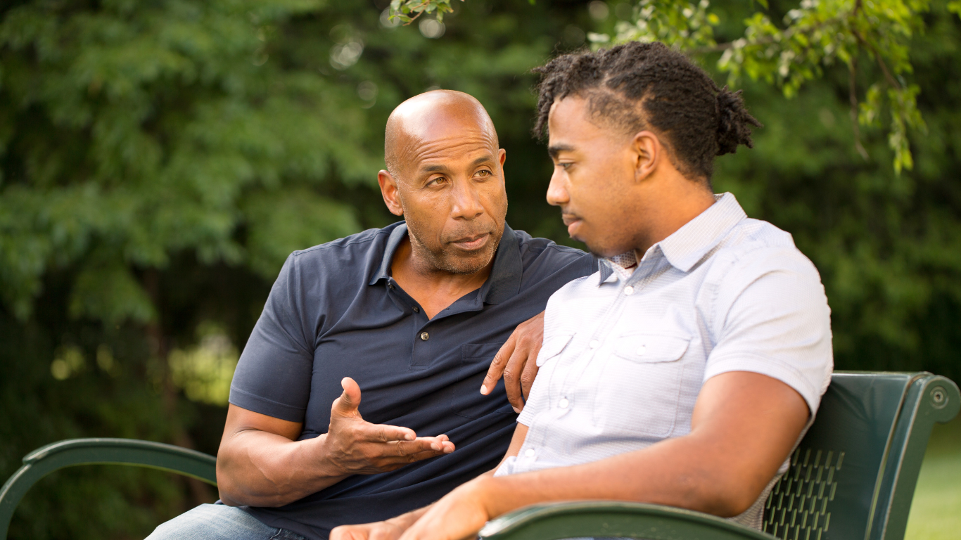 image of a man and young person sitting on a bench