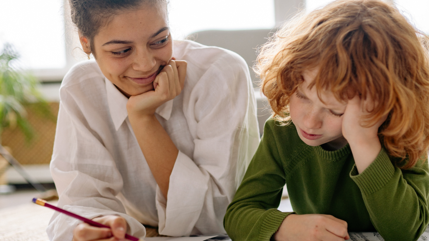 image of a child and adult lying on the floor working