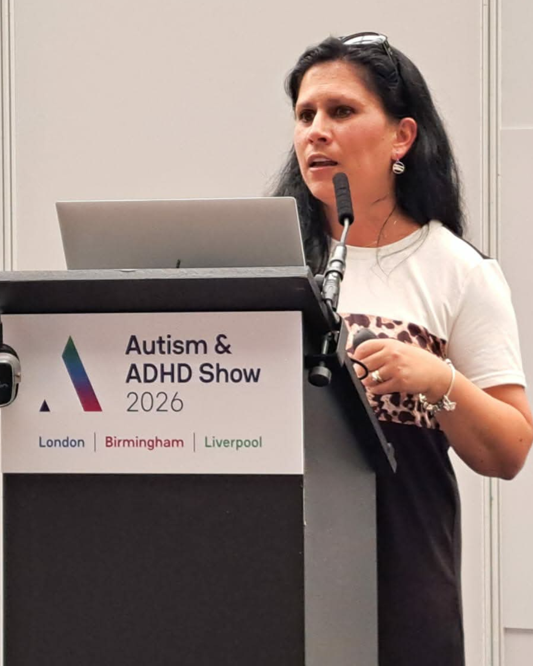 image of Teo standing on stage speaking